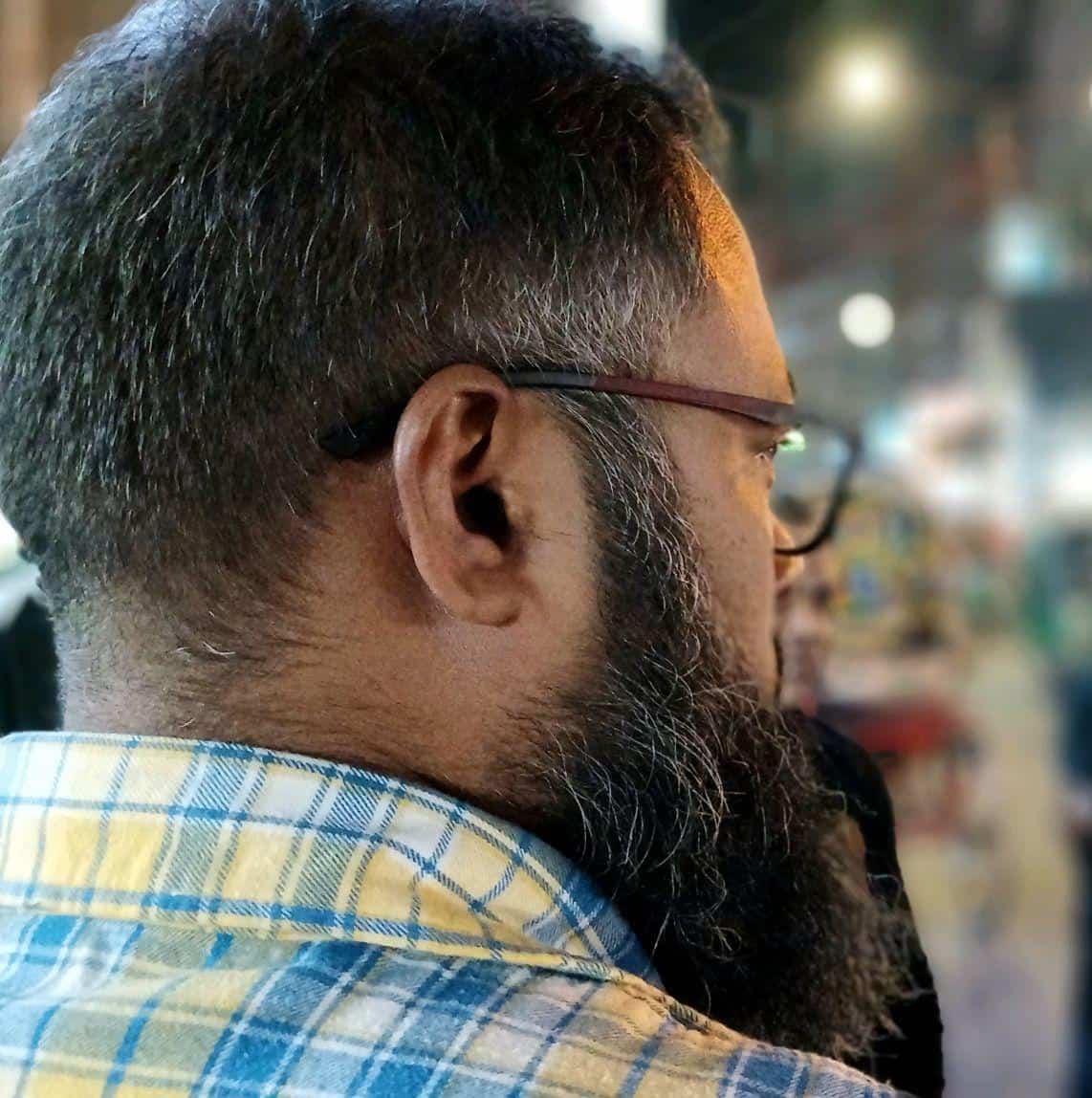Man shopping at organic store with healthy products on display.